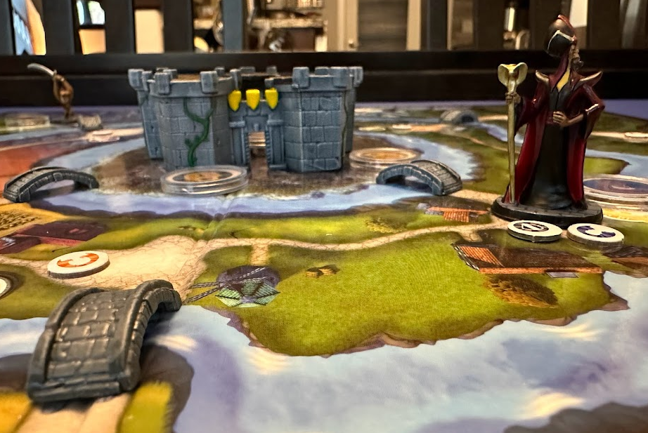 Painted mins of Jafar, a bridge, and the castle on the game board