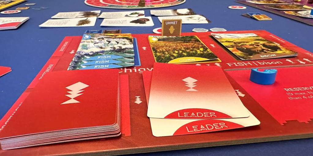 Close up of a player board, cards, and tokens.