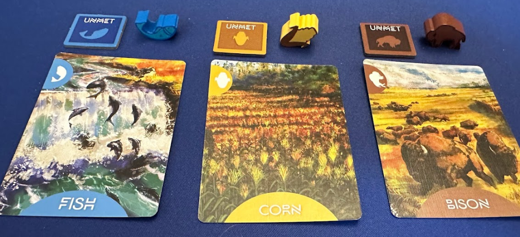 Resource cards showing full art as a painting, iconography. Unmet Tokens and wooden resources for Fish, Corn, and Bison.