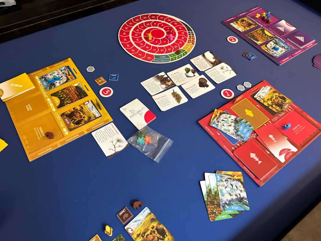 Wolves game components on a blue table for a 3-player game.
