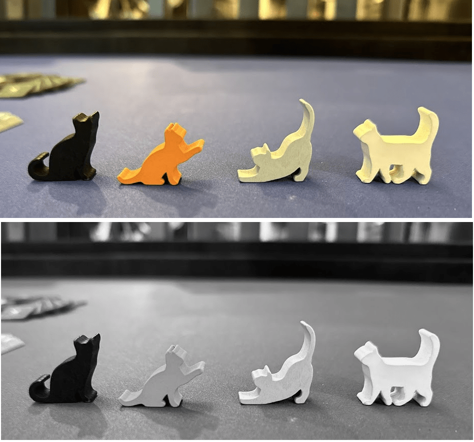 Close up of 4 cat tokens shown in both full-color and greyscale.