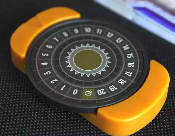 Circular chip with numbers 0-20, placed in a plastic chip holder.