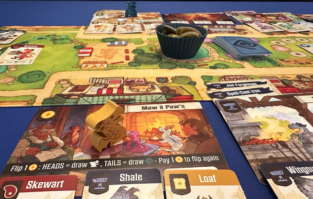 Close up of cards, game board, and game components for Flamecraft.