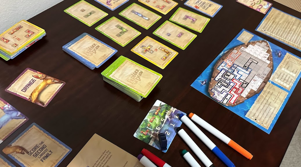 Cards, game board, and markers for The Isle of Cats: Explore & Draw.