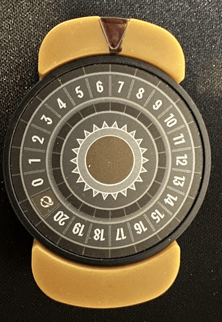 Circular chip with numbers 0-20, placed in a plastic chip holder, with the triangular notch colored in black.