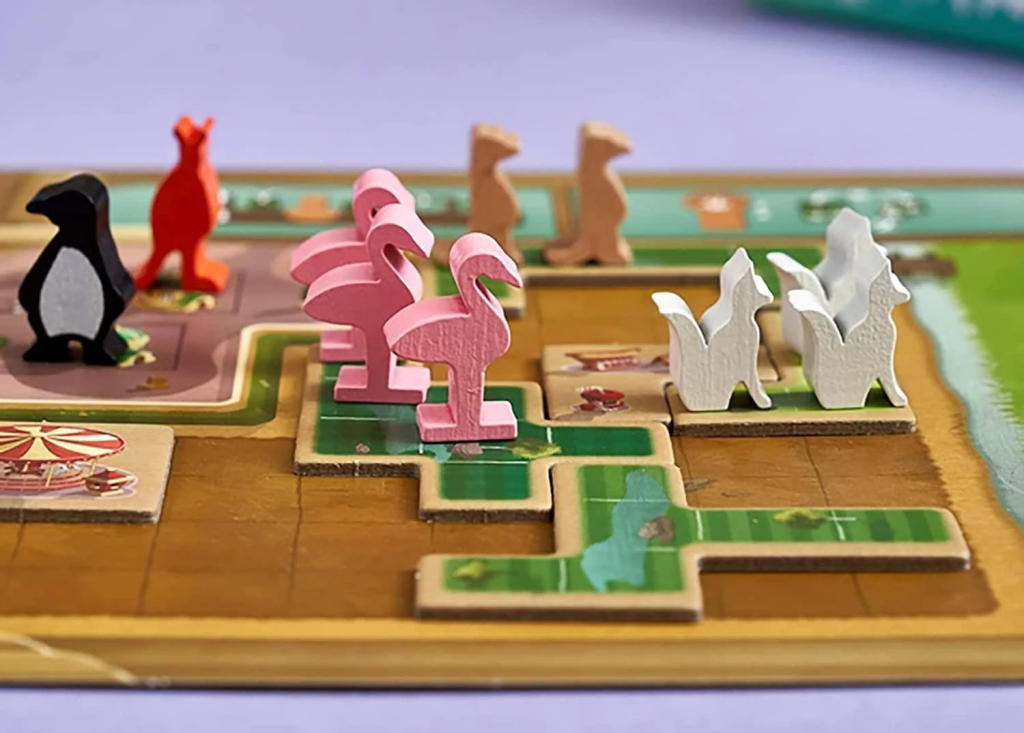 Various animal meeples on the New York Zoo game board