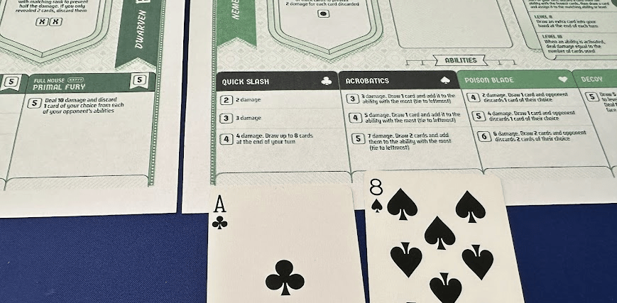 A game board featuring various abilities and actions for a tabletop game, with an Ace of clubs and an Eight of spades playing cards displayed in front.