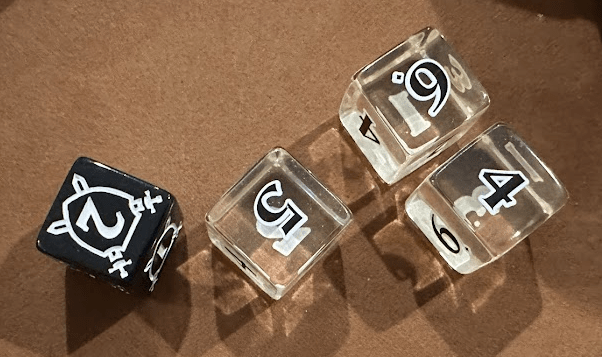 Close up of 3 transparent dice and one black die.