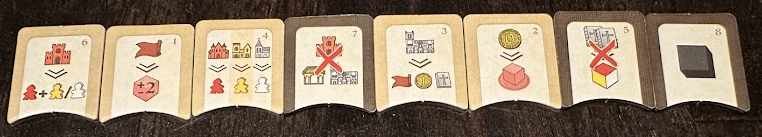 8 small tiles on dark wood table