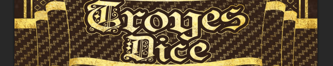 Troyes Dice words in yellow on a black backgound